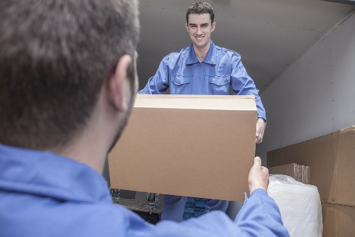 Flat removals team handling furniture in a Camden apartment building