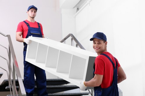 Movers carrying items through a Camden apartment building
