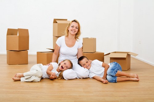 Moving team assisting with furniture relocation for a Camden family home