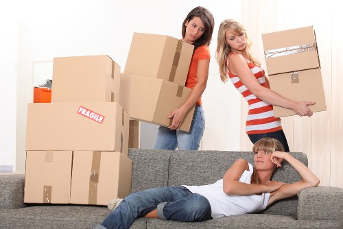 Team carrying household items down stairs in a Camden property